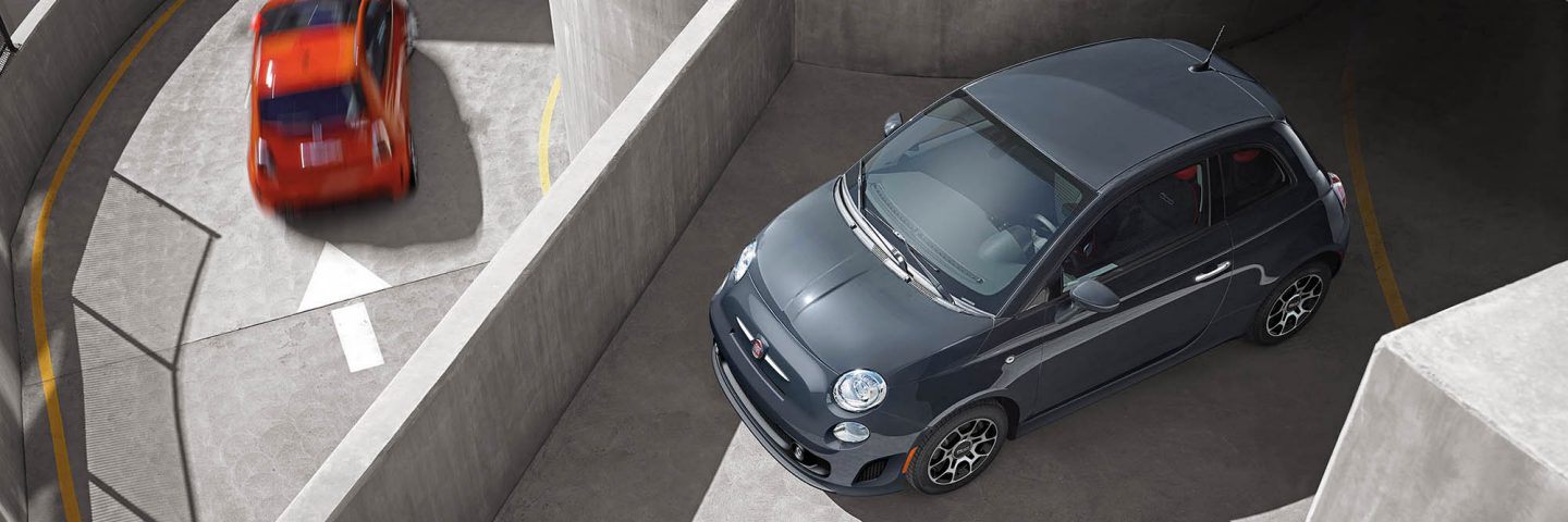 Overhead view of a 2019 Fiat 500 Pop parked on the roof of a parking structure.